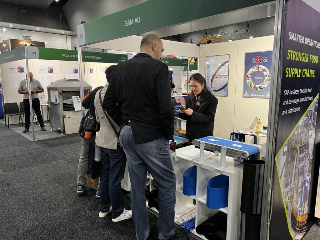 Customers visiting GM Belting booth at Foodpro Melbourne 2026 for belt solutions consultation