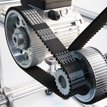 Curvilinear tooth timing belt engaged with a grooved pulley for accurate industrial power transmission.