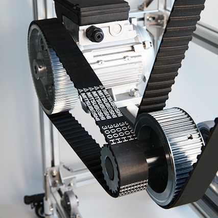 Rubber timing belt with trapezoidal teeth running on a pulley, available from G&M Belting Australia.